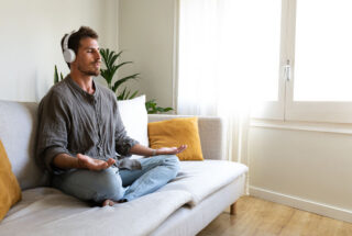 Man meditates with headphones on during meth addiction treatment in Florida.