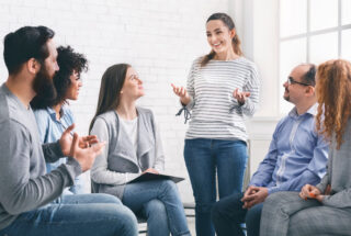 Woman stands in group therapy for meth addiction in Florida.