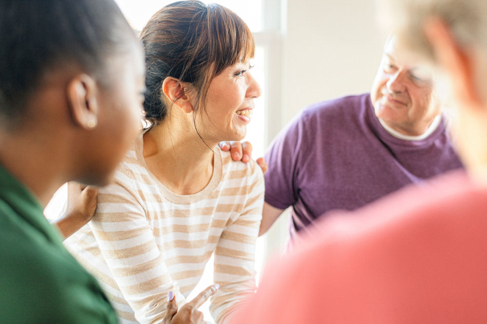 Man reassuring woman during group therapy in cocaine rehab in Florida.