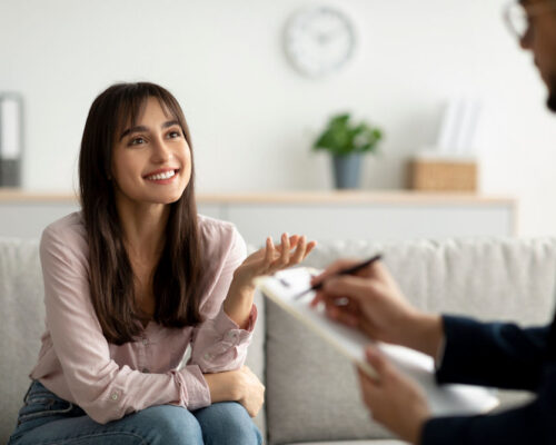 woman smiling in therapy for addiction