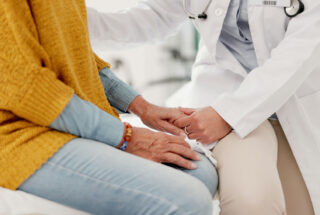 Doctor reassures young woman about treatment for prescription drug addiction.