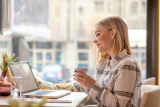 Woman back at work on her laptop, staying on track with addiction aftercare