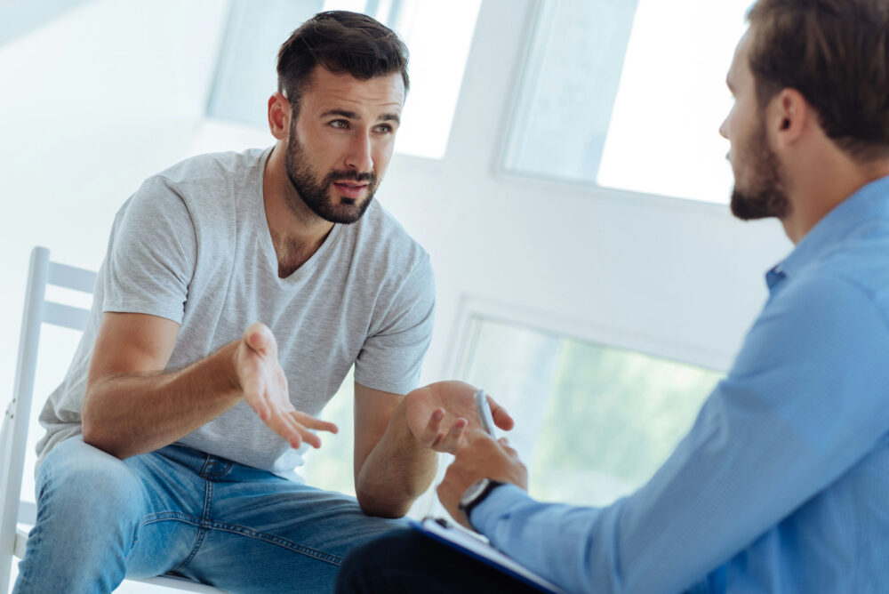 Man talking with his therapist about his recovery goals