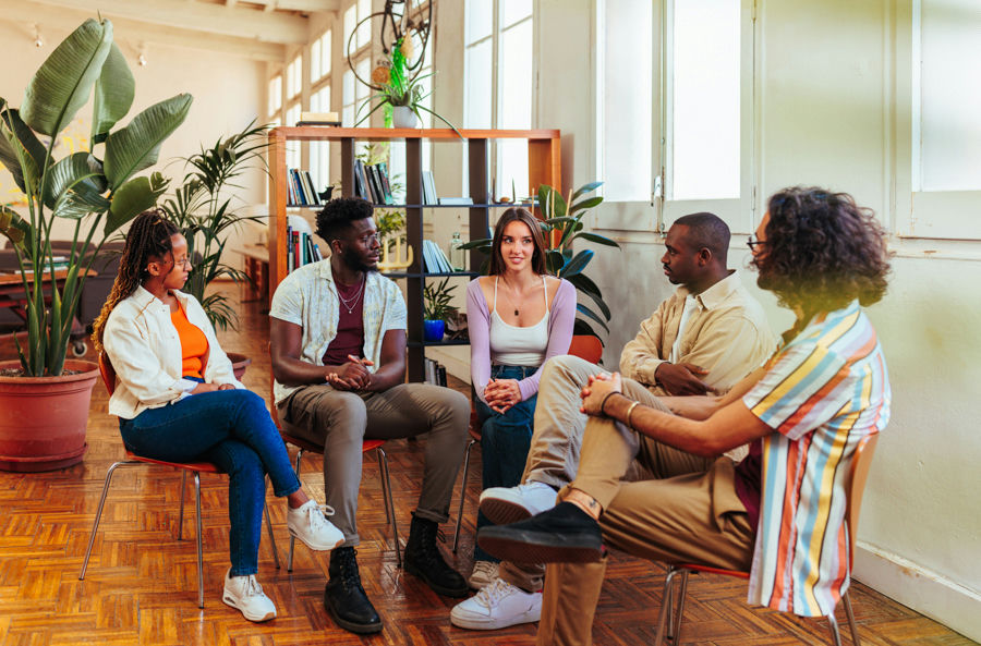 Young adults talking openly in an aftercare support group