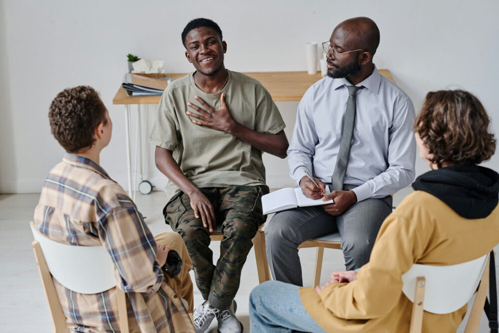 Small group sharing in a circle during an ongoing addiction aftercare session