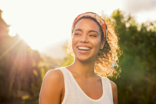 Young woman smiling in the sunshine during recovery from polysubstance addiction