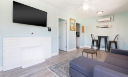 Modern living area with a comfortable sectional couch, a TV on the wall