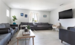 Spacious living room featuring a cozy gray sofa