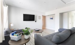 Cozy and bright living area with a TV mounted on the wall