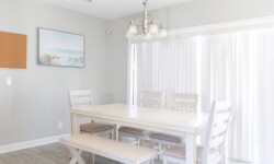 Bright dining area with a white table and six chairs